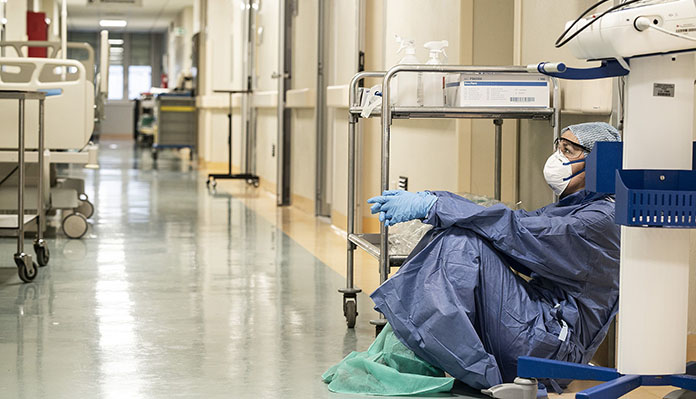 An exhausted nurse at the San Salvatore Hospital in Pesaro, Italy